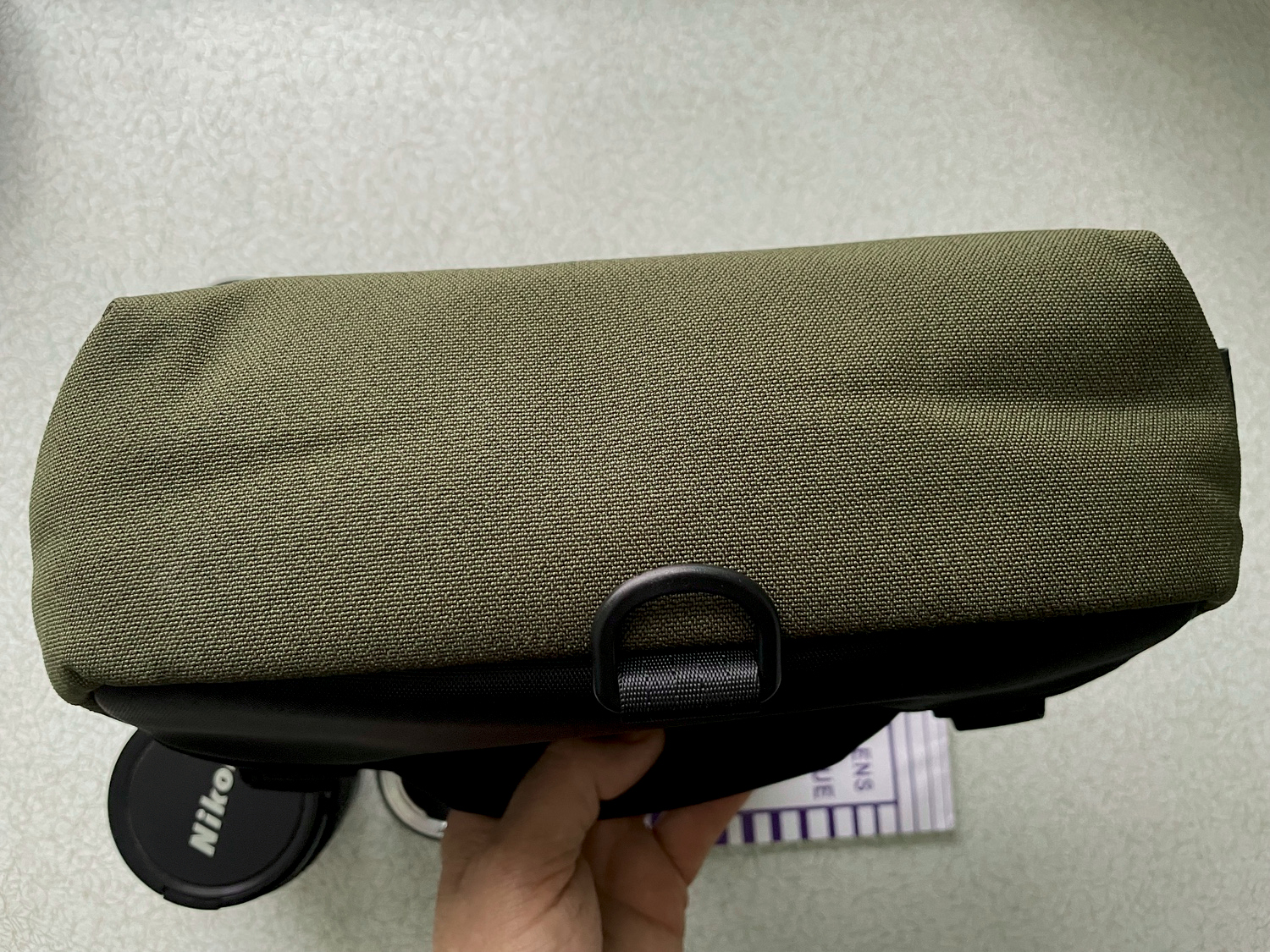 The plastic D-ring on the bottom rear.